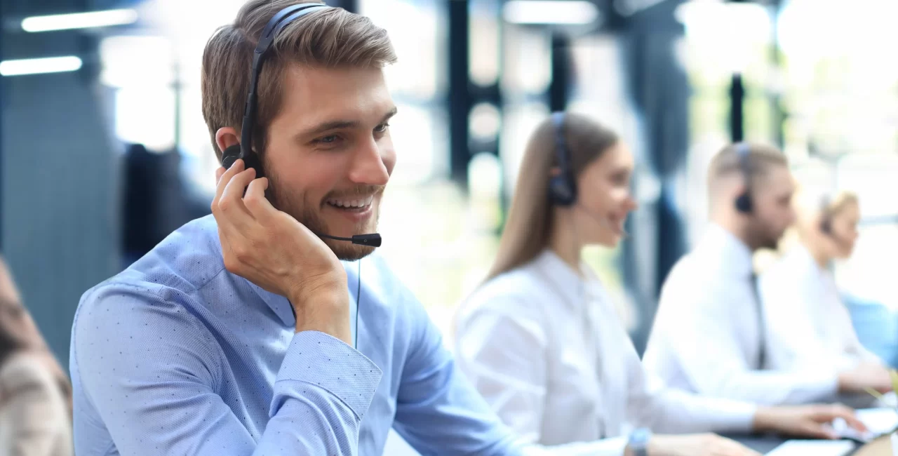 portrait-call-center-worker-accompanied-by-his-team-smiling-customer-support-operator-work copy3